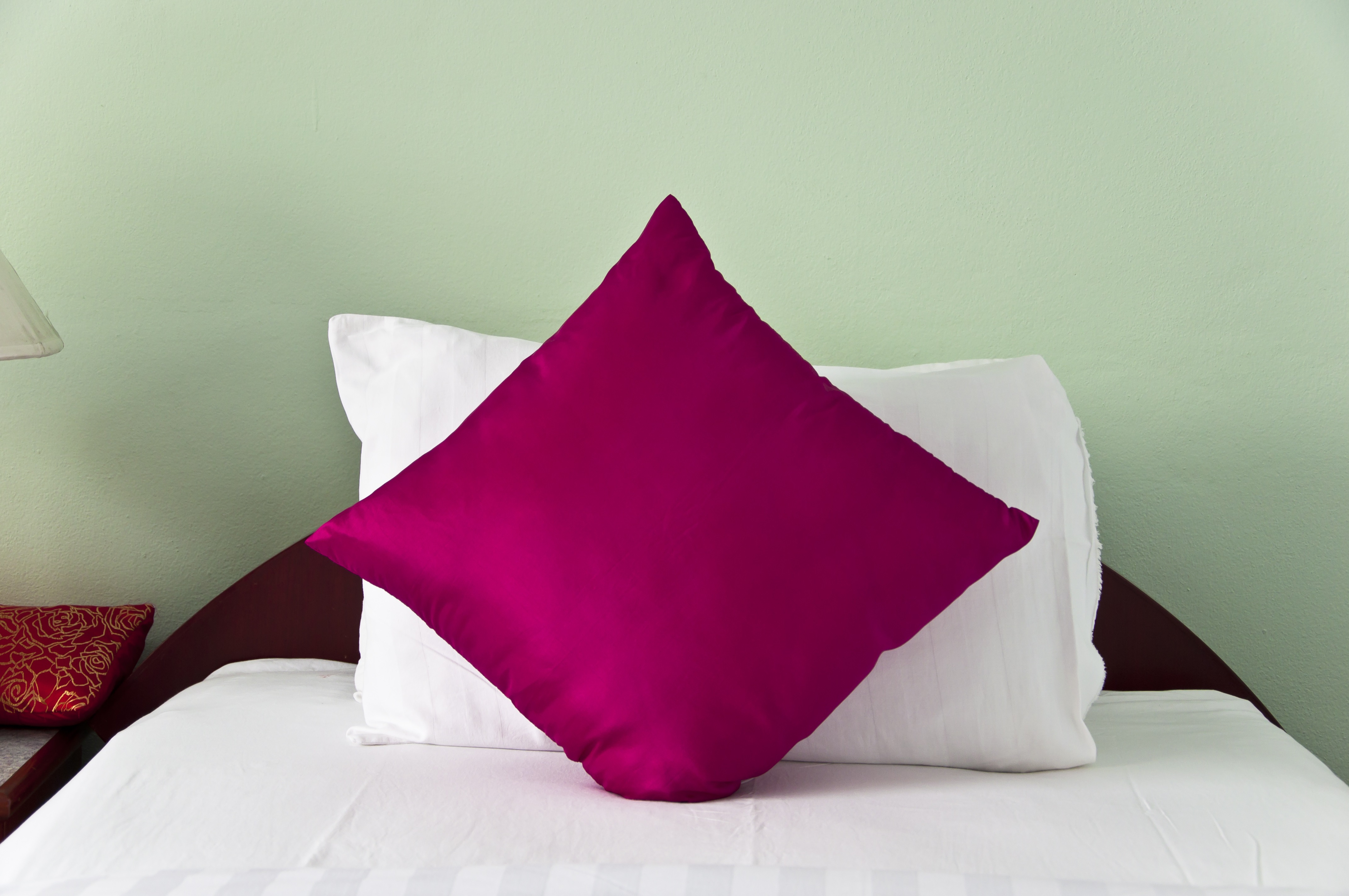 Bedroom with single pink pillows.